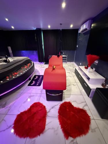a room with red ruffles on the floor and a bed at Love Room Attitude in Grenoble