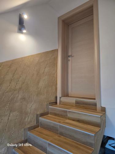 a set of stairs with a door in a house at Vila Mara in Gornja Toplica