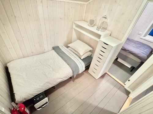 a small bedroom with a bed and a desk at Riverfront house with 98 inch TV, ps5 & activities in Narvik