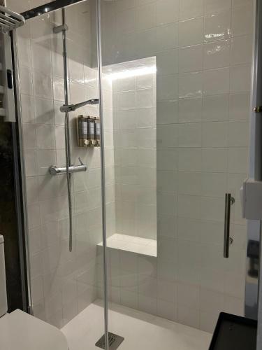 a shower with a glass door in a bathroom at Mirada Do Roxo in Oia