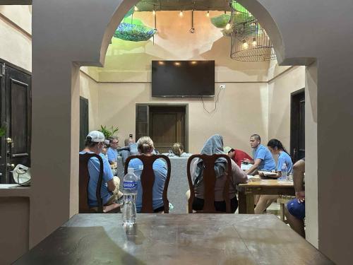 a group of people sitting at a table in a restaurant at Yojoa House Mountain Retreat in Santa Cruz de Yojoa