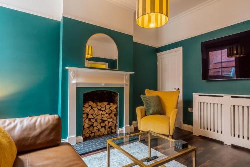 a living room with a fireplace and a chair at College Avenue Stay in Leicester