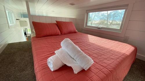 a bedroom with a bed with towels on it at Rate Drop! Enjoy the Simplicity-Teton Tiny House L in Tetonia