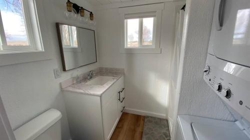 a white bathroom with a sink and a mirror at Rate Drop! Enjoy the Simplicity-Teton Tiny House L in Tetonia
