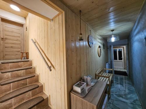 a room with wooden walls and stairs with a bench at Wellness Toliar Tatry in Stará Lesná