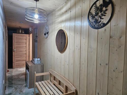 a room with a wooden wall with a wooden bench at Wellness Toliar Tatry in Stará Lesná