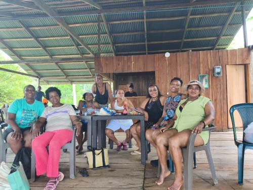 a group of people sitting at a table at Cabaña y restaurante vikana in Nuquí