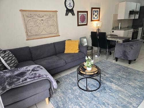 a living room with a couch and a table at Scott Sandton Apartments & Cozy Escapes in Sandton