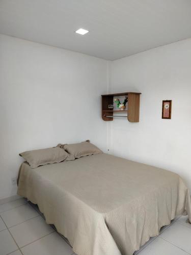 a bedroom with a bed in a white room at Pousada Tendawa in Santarém