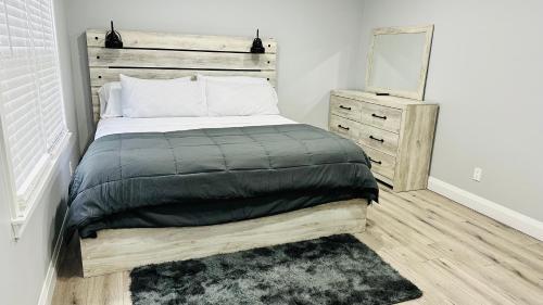 a bedroom with a bed with a wooden headboard at T&K modern spot 151 in Lilburn