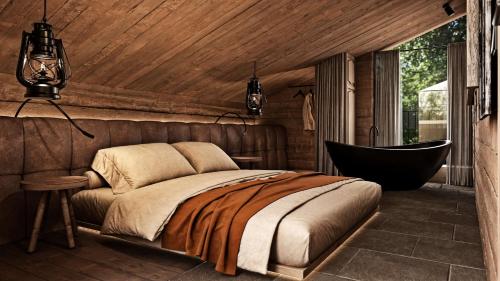 a bedroom with a bed and a bath tub at EdeR FriDa - Tuttiii KomPletti ALL inKlusiv in Maria Alm am Steinernen Meer