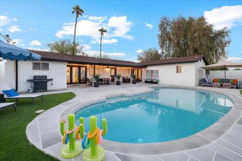 a swimming pool in a yard with a house at Cactus Bloom Villa - Spacious 5BR near Old Town Scottsdale with Private Pool in Scottsdale