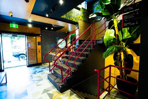 a staircase in a building with a potted plant at Brisbane Quarters in Brisbane