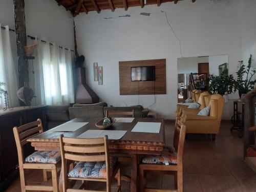a dining room with a table and chairs and a couch at Rancho Montilla, Great place to replenish energy! in Jambeiro