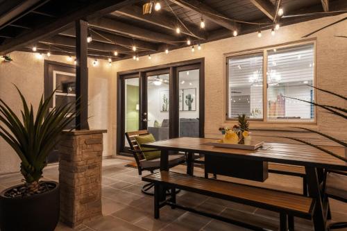 a dining room with a table and a bench at Cactus Bloom Villa - Spacious 5BR near Old Town Scottsdale with Private Pool in Scottsdale