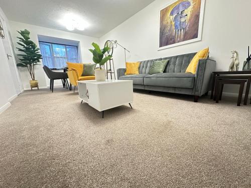 a living room with a couch and a table at Exquisite 2Bed Near Transport Link & Bluewater Mall in Stonewood