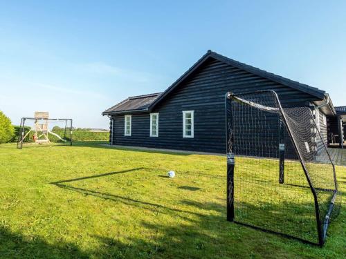 a yard with a soccer goal and a house at Luxury Lodge with Limfjord View - By Traum Ferienwohnungen in Spottrup