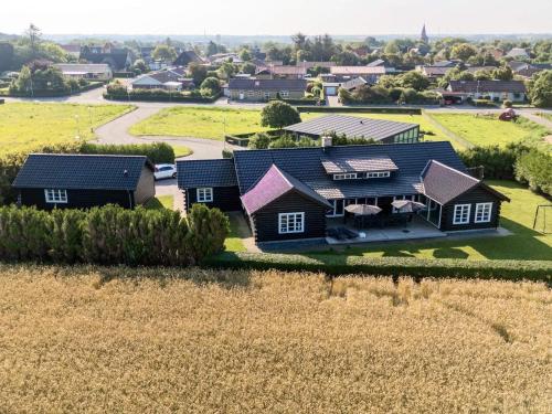 an aerial view of a house in a field at Luxury Lodge with Limfjord View - By Traum Ferienwohnungen in Spottrup