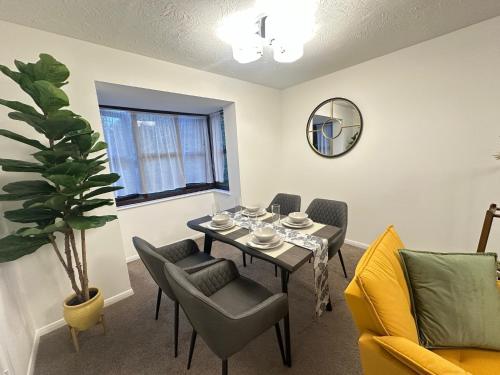 a dining room with a table and chairs at Exquisite 2Bed Near Transport Link & Bluewater Mall in Stonewood