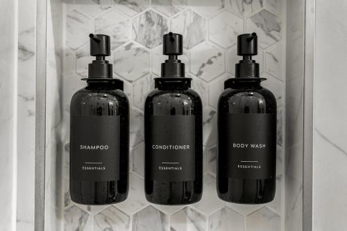 three bottles of shampoo and conditioner in a box at Chic and Cozy Stay in Pueblo in Pueblo
