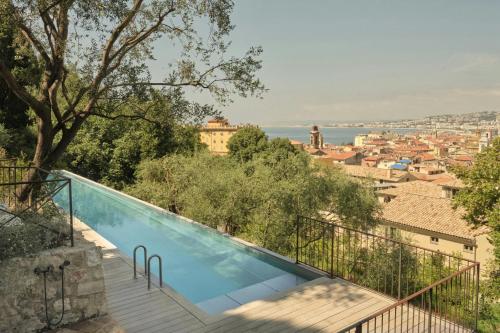 a swimming pool with a view of the city at Hôtel du Couvent, a Luxury Collection Hotel, Nice in Nice