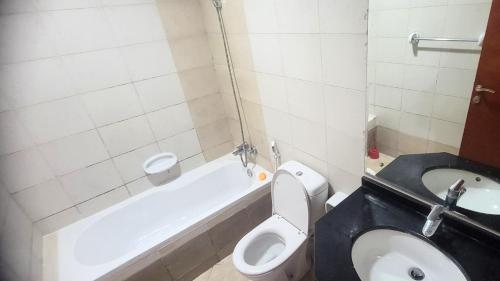 a small bathroom with a toilet and a bath tub at ASDK Home 908-14 in Dubai