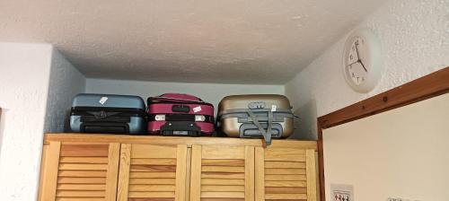 a pile of luggage sitting on top of a shelf at Residenza Verde Mare Cugnana village in Cugnana Verde