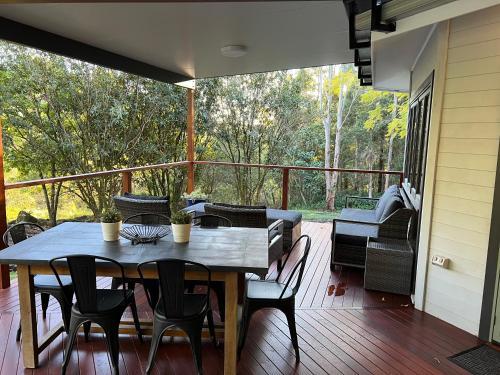 a porch with a table and chairs on a deck at Brightside Holidays in Landsborough