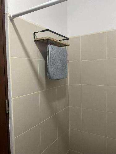 a bathroom with a shower with a towel on a shelf at Our Space in CasaMira Towers Mandaue Cebu in Mandaue City