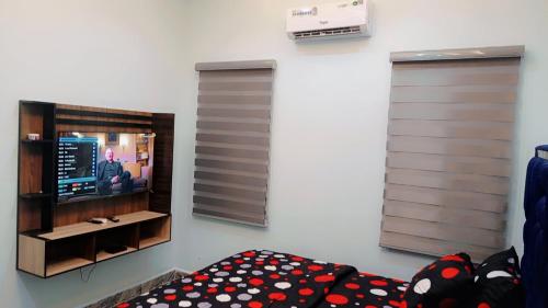 a living room with a tv and a couch at Daprem Luxury Self Contained Apartments in Uyo