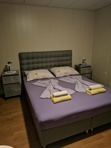 a bedroom with a bed with two towels on it at Apartments with parking space Lopar, Rab - 5019 in Lopar