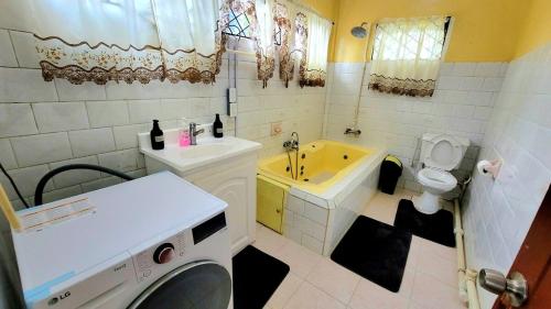 a bathroom with a sink and a washing machine at South Oasis in Georgetown
