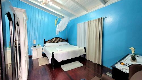a blue bedroom with a bed and a blue wall at South Oasis in Georgetown