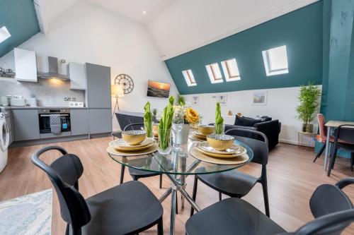 a dining room and living room with a table and chairs at Belgrave Chapel - Luxurious Apartment in Darwen