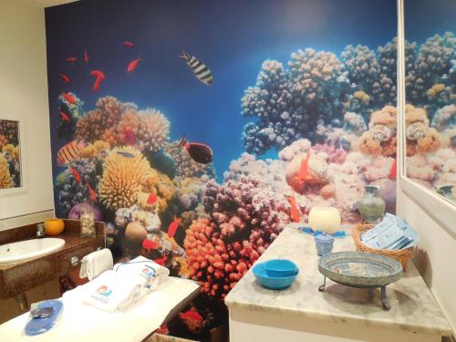a bathroom with a fish mural on the wall at Playasol in Roquetas de Mar