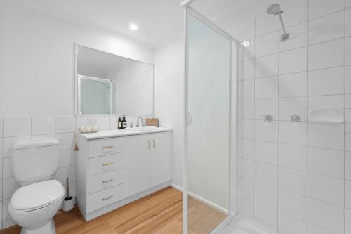 a white bathroom with a toilet and a shower at Candoux 2 AMS Mt Buller in Mount Buller