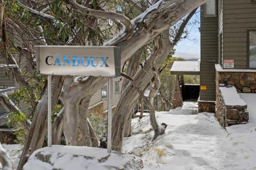 a sign in the snow in front of a house at Candoux 2 AMS Mt Buller in Mount Buller