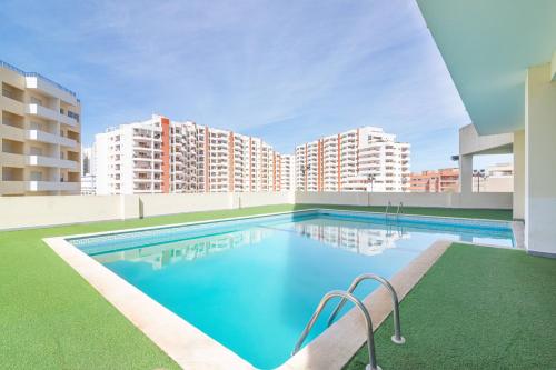 a swimming pool on the roof of a building at Mira Sol - Silhueta Citadina in Portimão