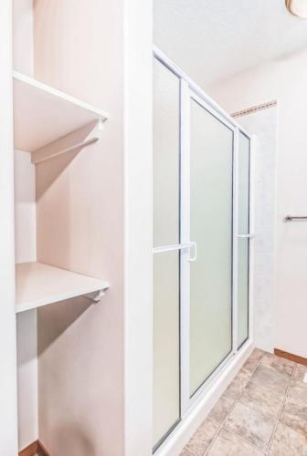 a walk in closet with a sliding glass door at Master Bedroom with attached bathroom in Airdrie