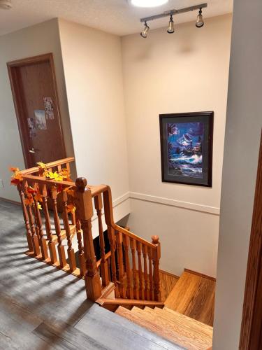 a room with a wooden staircase with a painting on the wall at Master Bedroom with attached bathroom in Airdrie