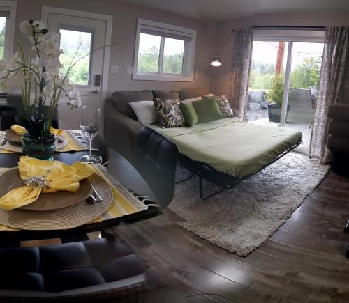 a living room with a couch and a table at Cowichan Calling in Lake Cowichan