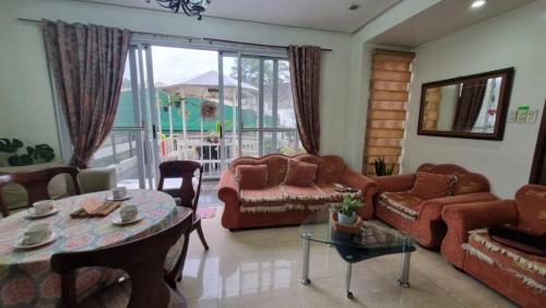 a living room with a couch and a table at Baguio Brentwood Villas in Baguio