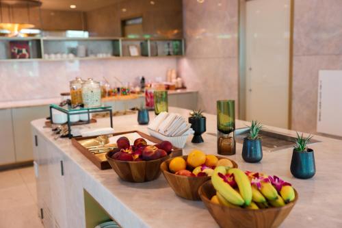 three bowls of fruit on a counter in a kitchen at Fairmont Century Plaza Los Angeles at Beverly Hills in Los Angeles