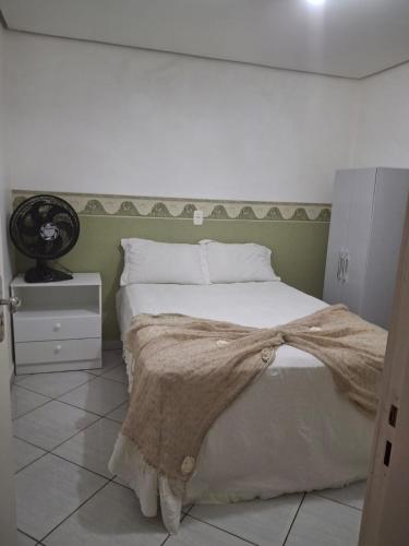 a bedroom with a bed with a blanket on it at Edifício Vitória 1 Apt 501 in Marcelino Ramos