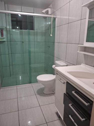 a bathroom with a toilet and a glass shower at Edifício Vitória 1 Apt 501 in Marcelino Ramos