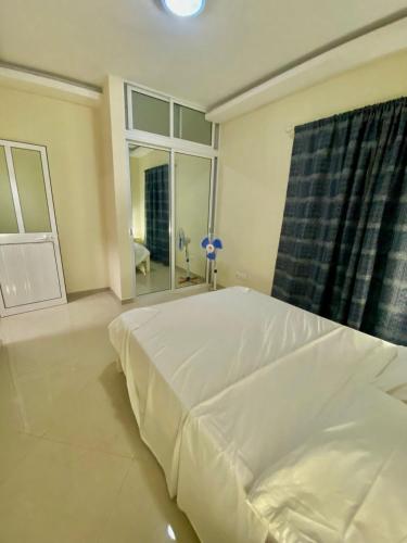 a white bed in a room with a window at Monte do Bem-Estar in Tarrafal