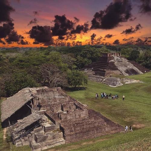 a group of people standing at the ruins of a pyramid at Los Fundadores Estancia Ecológica in Comalcalco