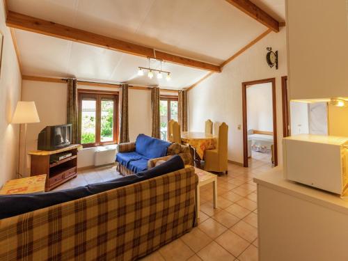a living room with a couch and a tv at Holiday Home in Bredene near Sea and Lake in Bredene