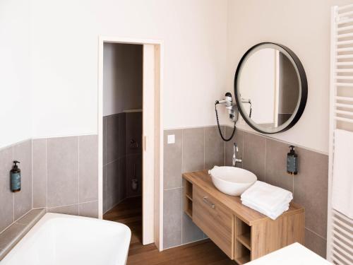 a bathroom with a sink and a mirror at Peaceful Bungalow Retreat in Antoing