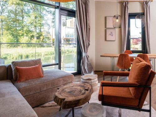 a living room with a couch and a table at Cozy Bungalow by the Lake in Antoing